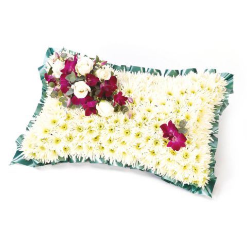 A classic pillow-shaped design created using a mass of white double spray chrysanthemums and finished with a spray of white large-headed roses and purple dendrobium orchids.